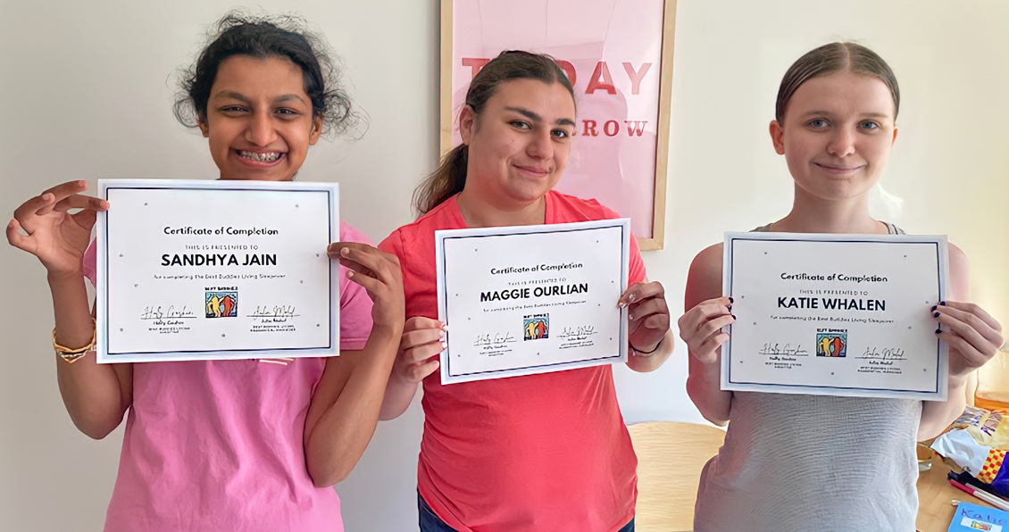 lead-living Three girls proudly show their Certificate of Completion for the Best Buddie's Sleepover.