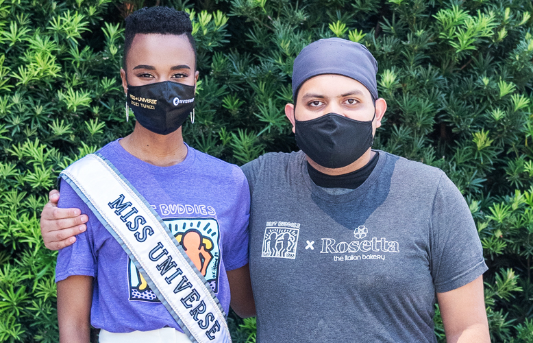 Miss Universe 2020 poses with a Rosetta Bakery Employee in Miami, Florida. Miss Universe 2020 poses with a Rosetta Bakery Employee in Miami, Florida.